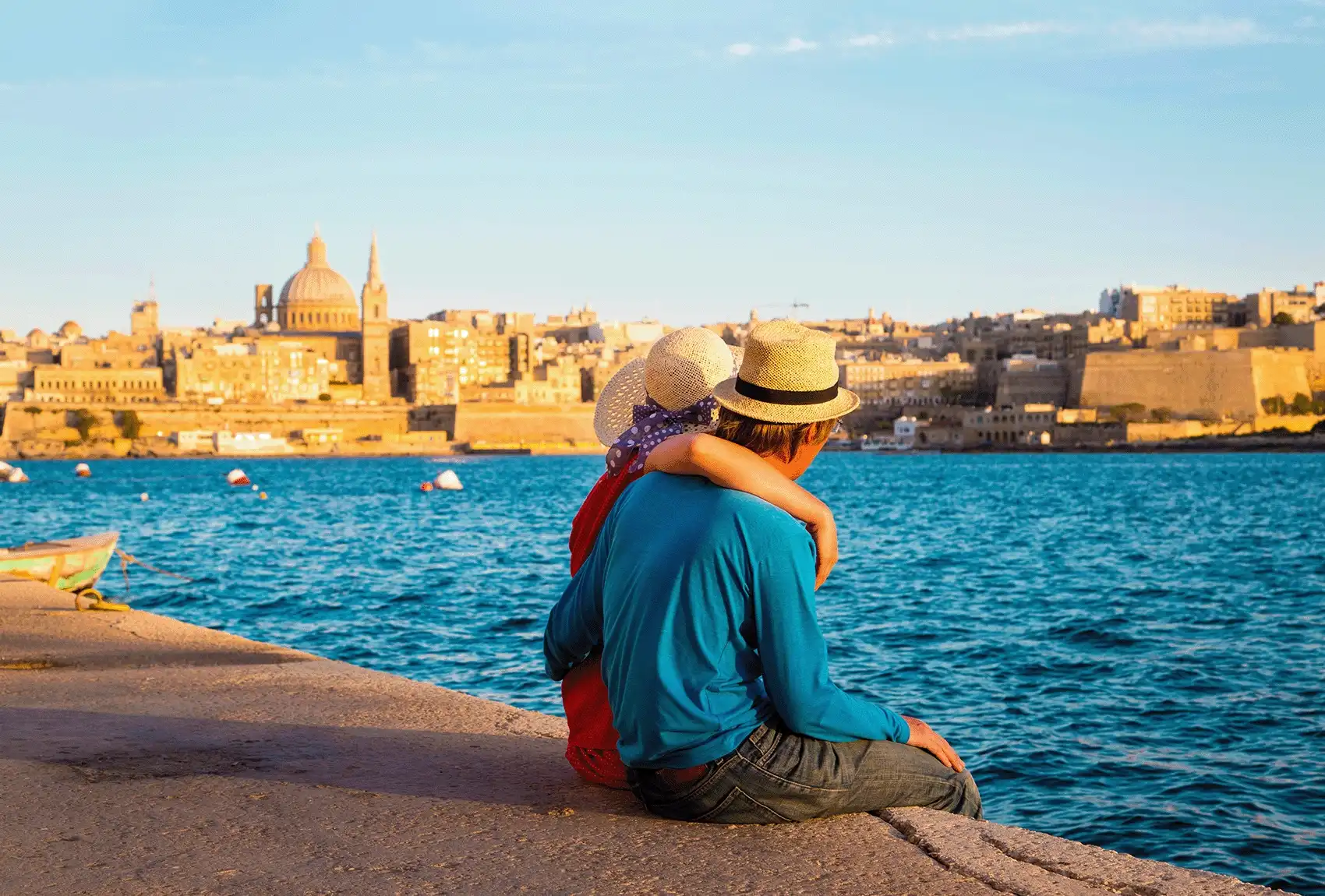 Couple relaxing by the sea in Malta.
