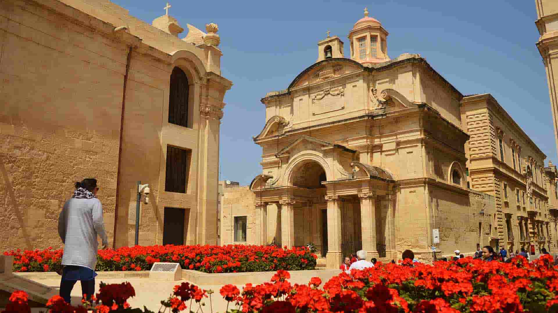 A woman staring at St. Catherine's Valletta church.