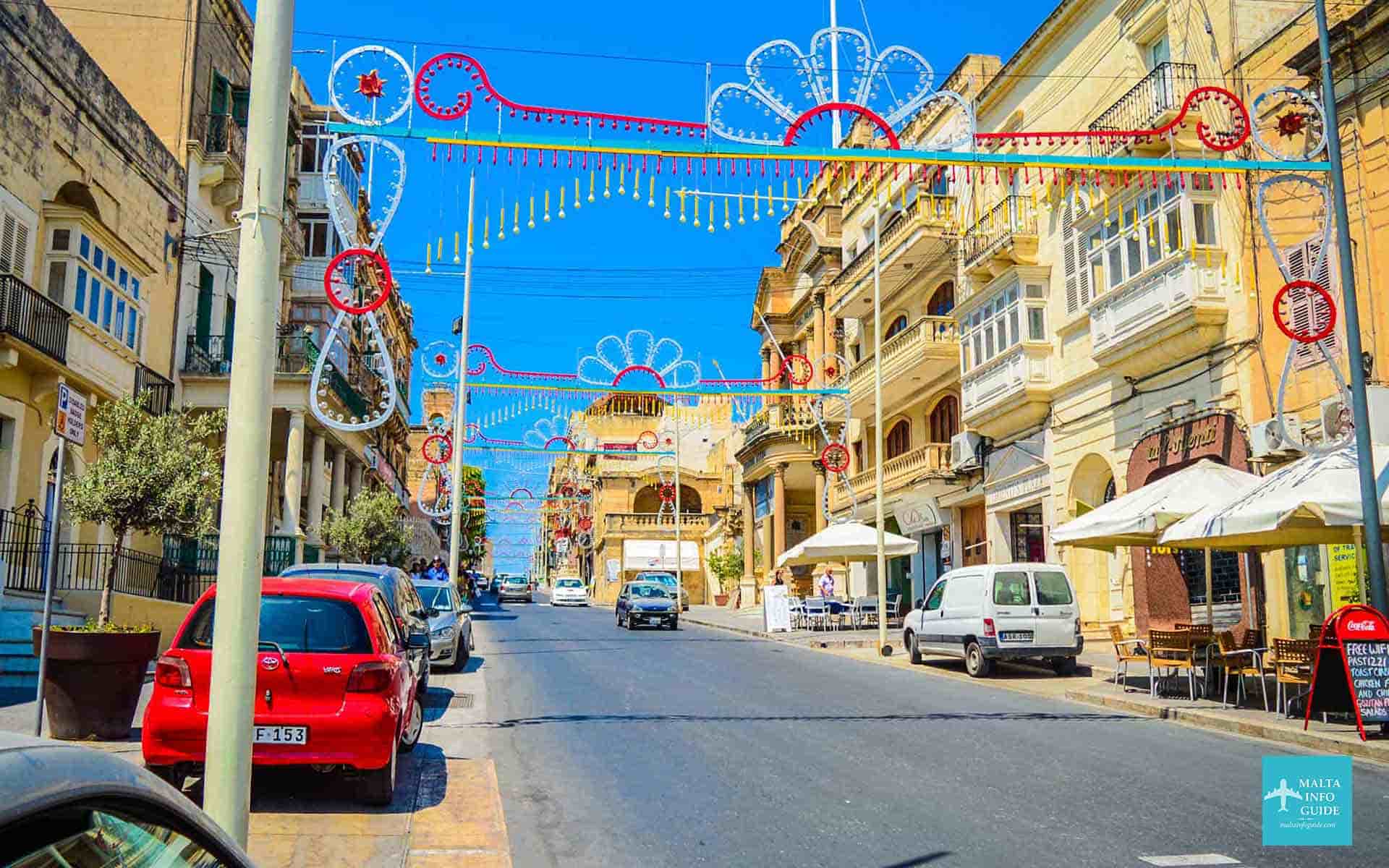Cars driving in Malta on the main road in Gozo's capital city Victoria.
