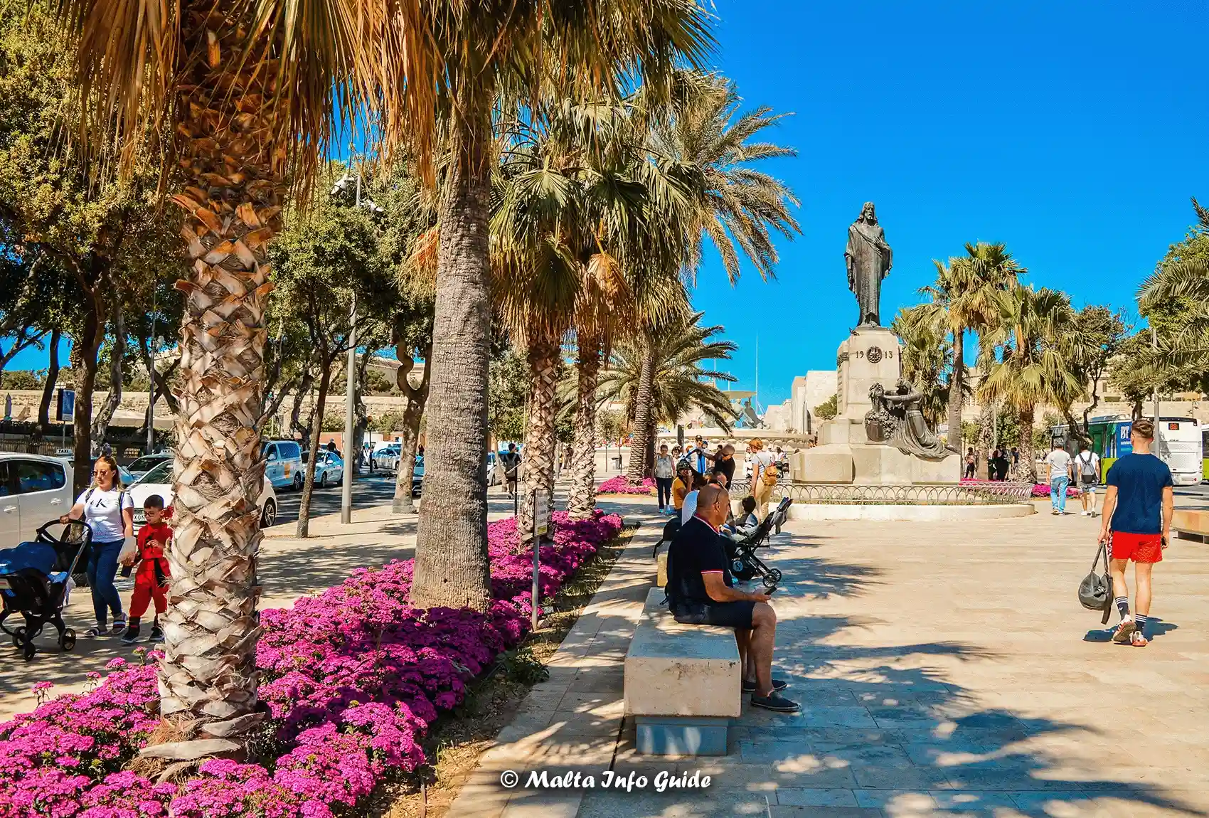 Palm-lined parking area near Valletta with visitors walking nearby.