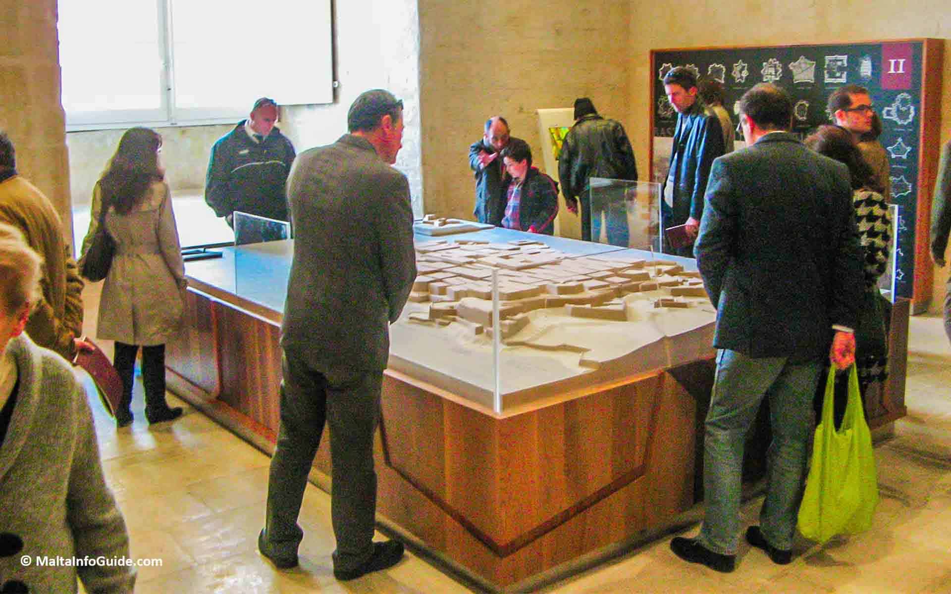 People having a look at the models of the museum.