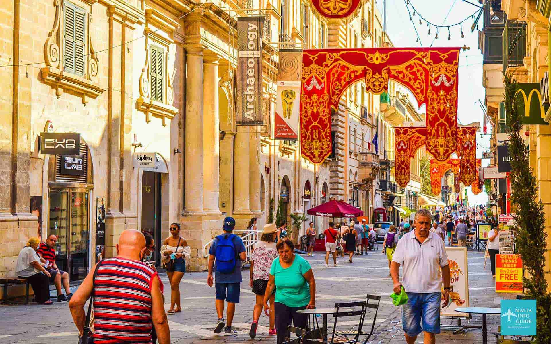 People walking Republic street Valletta during the feast in August.