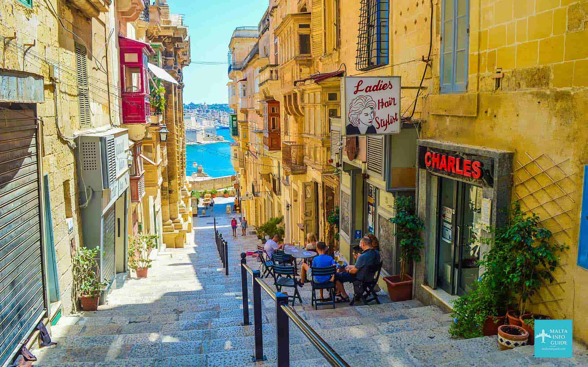 People having a snack at a restaurants in one of Valletta's narrow streets. People having a snack at a restaurants in one of Valletta's narrow streets.