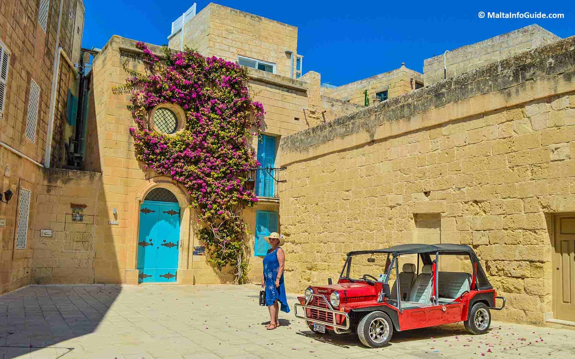 A lady posing in front of a popular Instagram sensation house in Mdina in Malta.