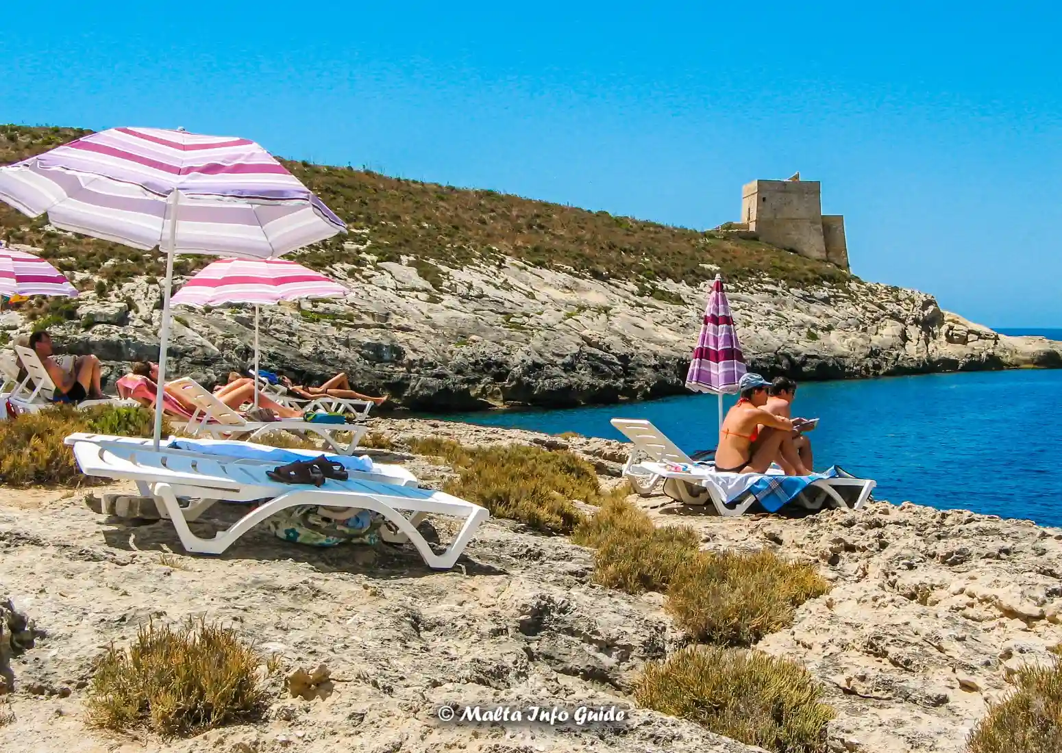 Rocky coast at Xlendi Bay in Gozo with Xlendi Tower.