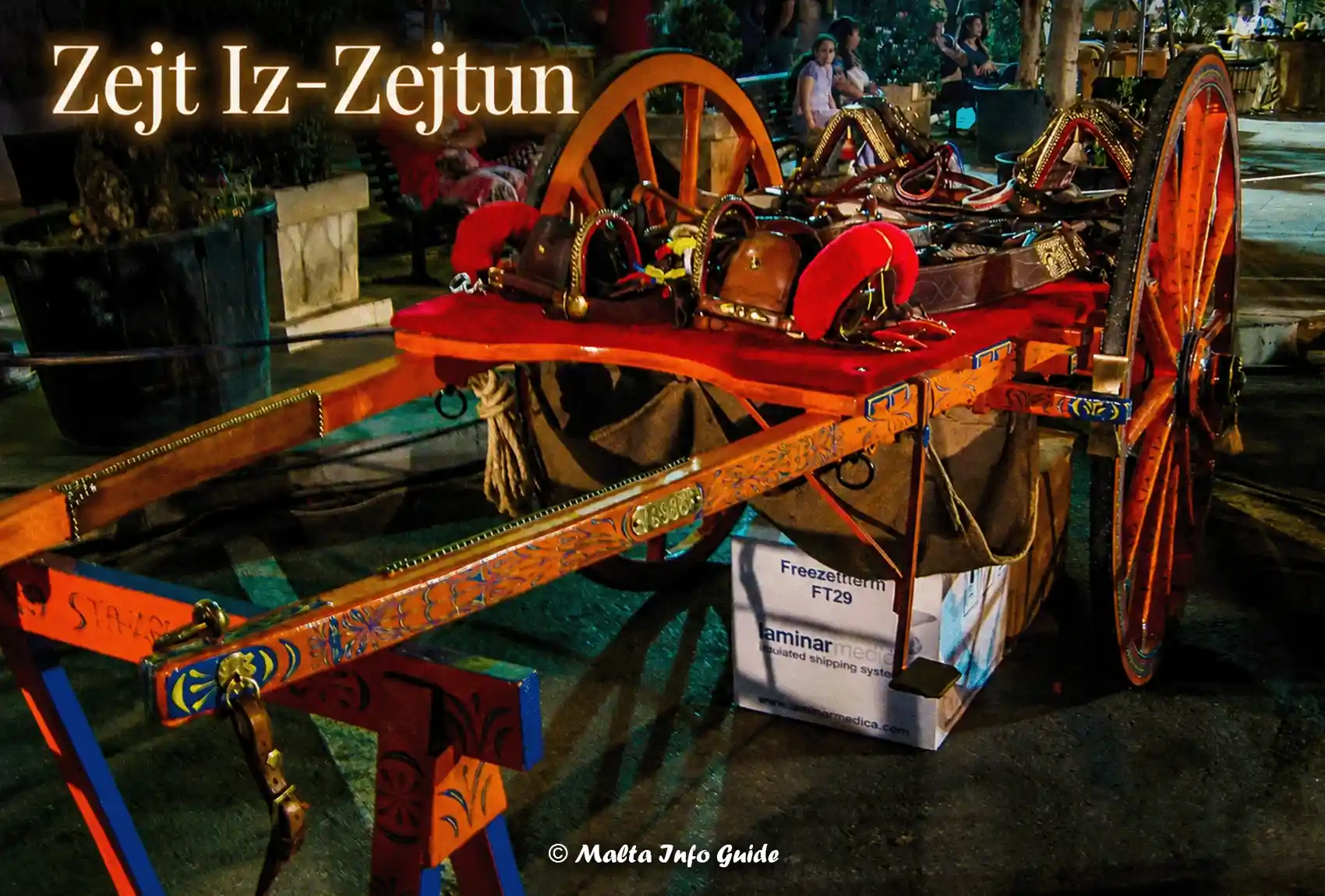 Traditional Maltese cart displayed during Zejt Iz-Zejtun at night.